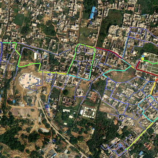 A satellite image shows a map of a city with colored lines indicating water network.