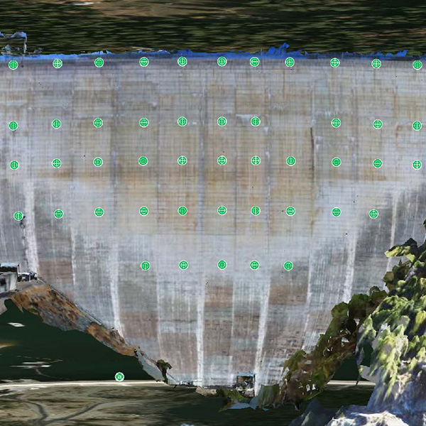 An image of a dam with green dots on it.